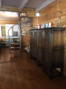 an old wooden cabinet in a room with a staircase at Chalet Paola in Assergi