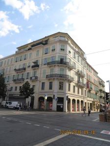 um grande edifício branco na esquina de uma rua em Résidence Appartement Adonis em Nice