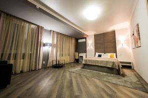 a hotel room with a bed and a large window at Mon Ami Villa in Chişinău