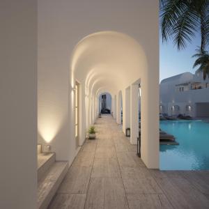 a corridor of a hotel with a swimming pool at Antoperla Luxury Hotel & Spa in Perissa