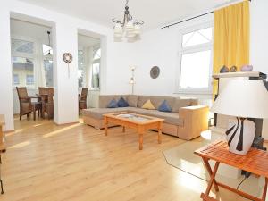 a living room with a couch and a table at Villa Sanssouci - Apt. 02 in Ostseebad Sellin +18 photos