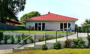 a white house with a red roof at VILLA SEE_RESIDENZ in Malchow