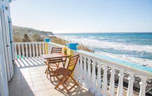 a balcony with a table and chairs and the ocean at Margarita & Filippos Apartments Corfu in Paramonas