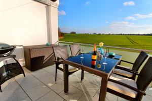 a patio with a table with drinks on it at Villa Grande Fewo Relax We 4 in Göhren-Lebbin