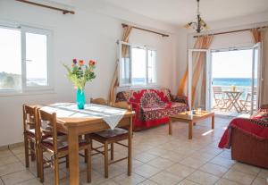 a living room with a table and a couch at Margarita & Filippos Apartments Corfu in Paramonas