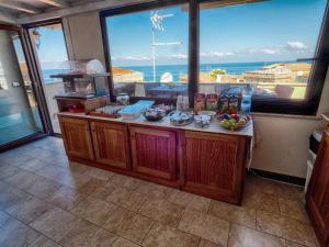 a kitchen with a counter with a view of the ocean at LoryLu in Tropea