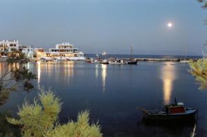 a harbor with boats in the water at night at San Antonio Summer House by GHH in Piso Livadi