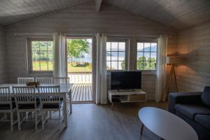 a living room with a couch and a table with a television at Kinsarvik Camping in Kinsarvik