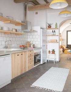 a kitchen with a sink and a stove top oven at HoMe Hotel Menorca in Ciutadella