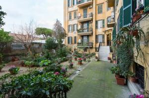 a courtyard in a building with flowers and plants at Rome Charming Suites in Rome