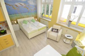 a small room with a bed and a chair at Villa Sirene - Wohnung 08 in Binz