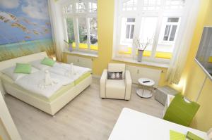 a small room with a bed and a table at Villa Sirene - Wohnung 08 in Binz