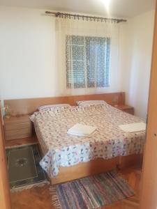 a bedroom with a bed and a window at Villa Maja in Omišalj
