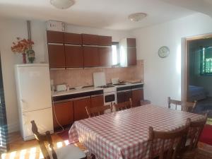 a kitchen with a table and a refrigerator at Villa Maja in Omišalj