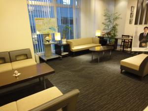 a living room with couches and chairs and tables at S Peria Hotel Nagasaki in Nagasaki