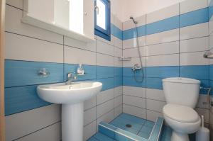 a blue and white bathroom with a sink and a toilet at Magic Summer in Agia Anna Naxos