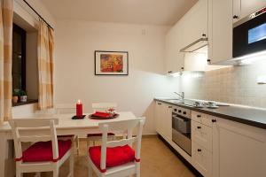 a kitchen with a table and chairs with a candle on it at Apartmany Hrabovo in Ružomberok