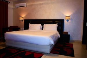 Voodi või voodid majutusasutuse Hotel Palm Beach toas