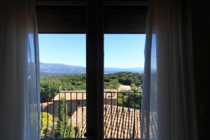 a window with a view of a mountain view at Ca La Conxita Hostal & Restaurante in La Vajol