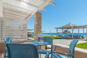a patio with chairs and a table and a gazebo at Kordistos Hotel in Kefalos