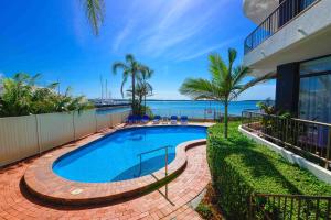 a swimming pool with a view of the ocean at Broadwater Shores Waterfront Apartments in Gold Coast