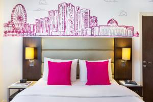 A bed or beds in a room at ibis Styles Sharjah