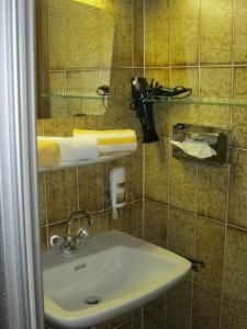 a bathroom with a sink and a mirror at Gasthof Talblick in Ischgl