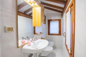 a bathroom with a sink and a toilet and a mirror at San Marco Romantic Dream in Venice +20 photos