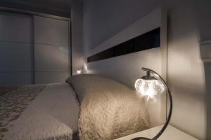 a bedroom with a bed and a lamp on a table at Paseo do Mar 2 in Ézaro