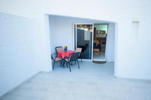 a dining room with a red table and chairs at Casa Lola in Agaete