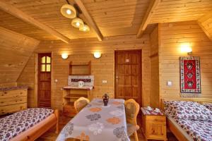 a dining room with a table and two beds at Pokoje Gościnne Pod Giewontem in Zakopane