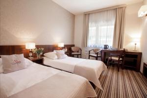 Łóżko lub łóżka w pokoju w obiekcie Park Hotel Diament Wroclaw