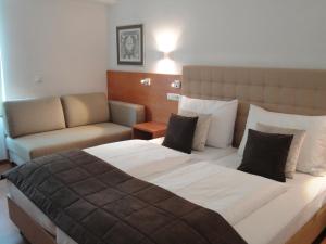 Ein Bett oder Betten in einem Zimmer der Unterkunft City Hotel Albrecht