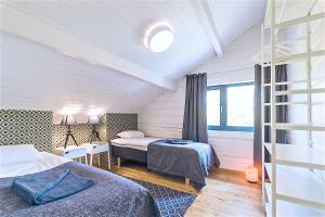 a bedroom with two beds and a window at Hapsal Spa Villas in Haapsalu