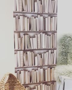 a book shelf filled with books in a room at Little Owl Barn in Marlborough