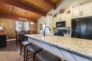 a kitchen with a large counter with bar stools at Phoenix 118 in Steamboat Springs