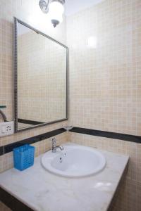 a bathroom with a sink and a large mirror at Tobias Villas in Cavelossim +8 photos