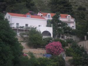 a house on the side of a hill with trees at House Smajić in Dubrovnik