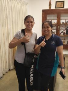 two women standing next to each other giving the thumbs up at Dions Guest House in Negombo