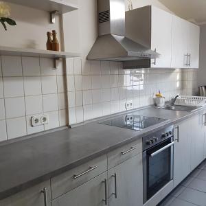 a kitchen with a sink and a stove at Pension Oase in Berlin