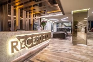 a reception area of a restaurant with a reception counter at Perelik Hotel in Pamporovo