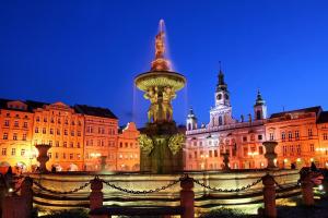 a large building with a fountain in front of it at Hotel Dvorak in České Budějovice