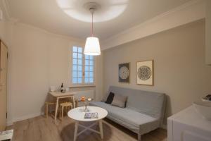 a living room with a couch and a table at Apollo Apartment @ Plaka in Athens