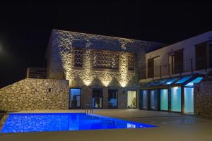 a building with a swimming pool at night at Vallantica Resort & SPA in San Gemini