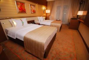 A bed or beds in a room at Holiday Inn Ankara-Kavaklidere by IHG
