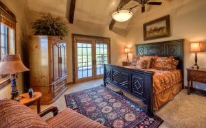 a bedroom with a bed and a couch at Antler Ridge Lodge in Big Sky