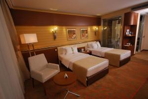 A bed or beds in a room at Holiday Inn Ankara-Kavaklidere by IHG