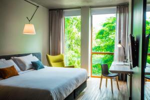 A bed or beds in a room at Five Hotel & Residences