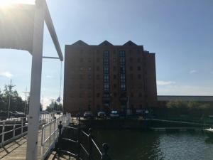 a large building next to a body of water at Marina Humber View Apartment in Hull