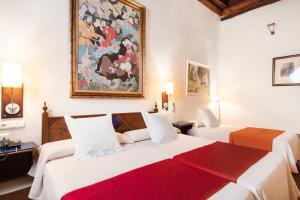 Postel nebo postele na pokoji v ubytování Casa Palacio Pilar del Toro